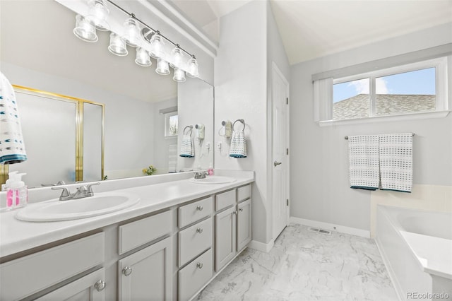full bathroom with marble look tile flooring, double vanity, a garden tub, a shower with shower door, and baseboards
