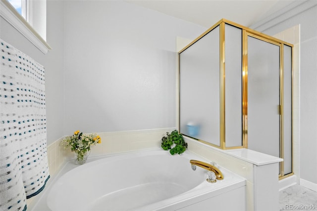 bathroom featuring a shower stall, a garden tub, and marble look tiles