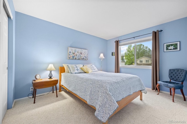 carpeted bedroom featuring baseboards
