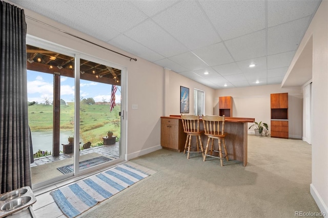 indoor dry bar featuring light carpet, baseboards, a paneled ceiling, and recessed lighting