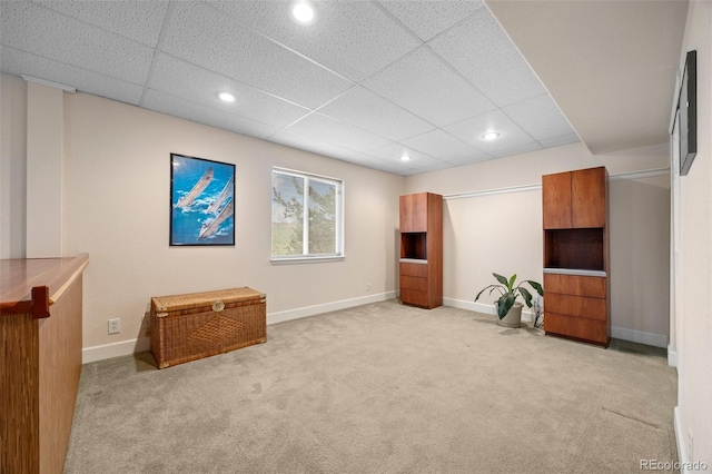 unfurnished room featuring light carpet, a paneled ceiling, baseboards, and recessed lighting