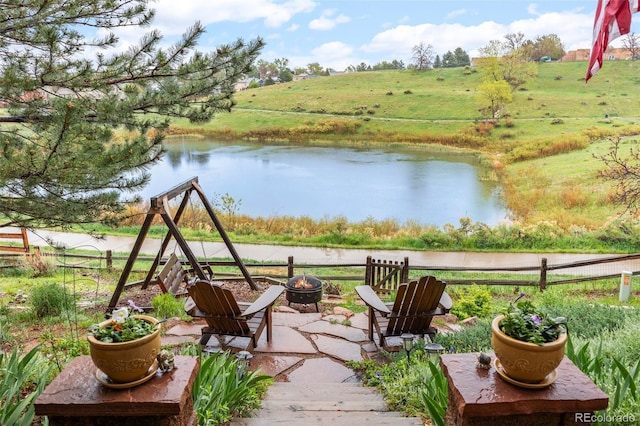 exterior space featuring a fire pit and a water view