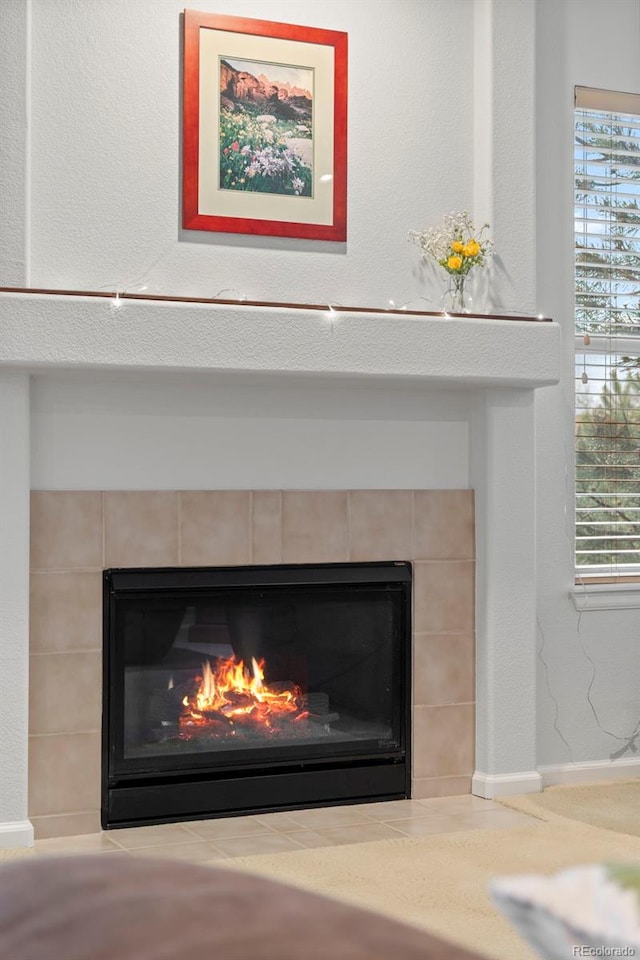 detailed view of a tiled fireplace and baseboards