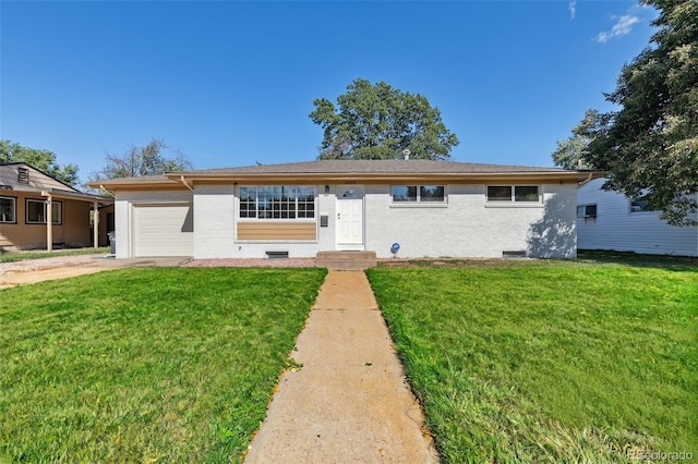 view of front of house featuring an attached garage, a front lawn, and brick siding