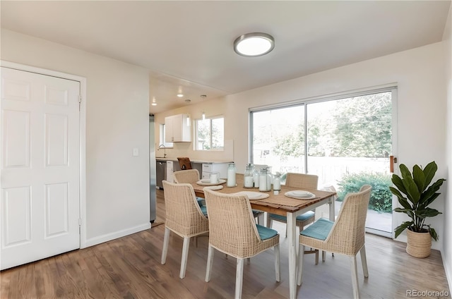 dining area featuring baseboards and wood finished floors
