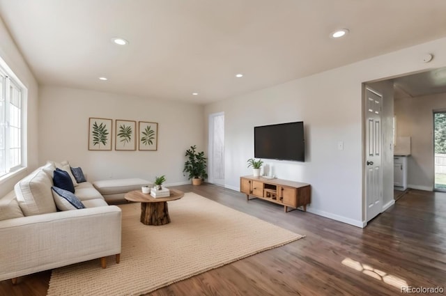 living room featuring baseboards, recessed lighting, and wood finished floors