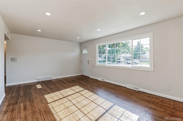 unfurnished room featuring visible vents, recessed lighting, baseboards, and wood finished floors