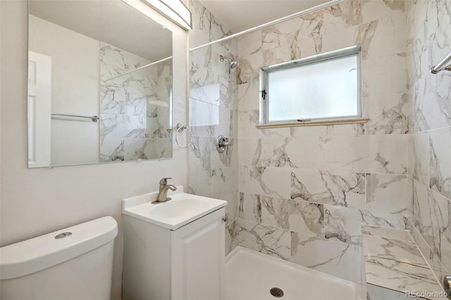 bathroom featuring vanity, a stall shower, and toilet