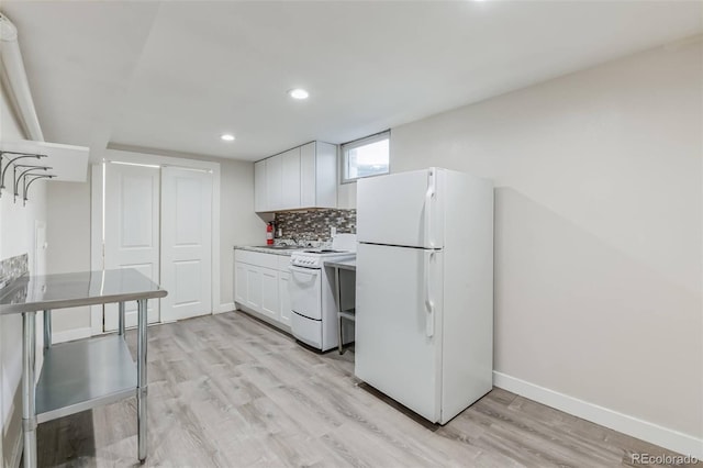 kitchen with white appliances, baseboards, light wood-type flooring, white cabinets, and backsplash