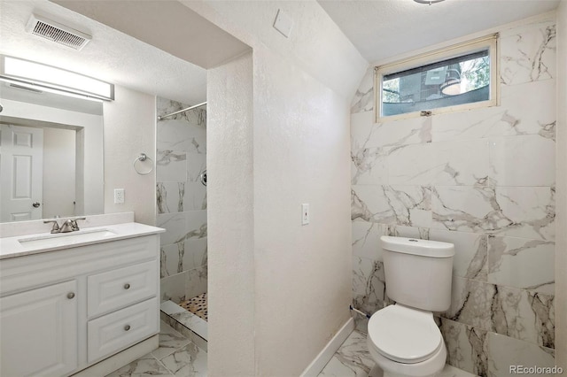 bathroom featuring vanity, toilet, marble finish floor, visible vents, and tiled shower