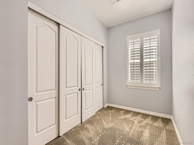11883 E Fair Ave, Greenwood Village, CO 80111 - unfurnished bedroom with carpet floors and a closet