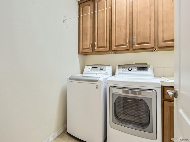 11883 E Fair Ave, Greenwood Village, CO 80111 - laundry area with cabinet space, washing machine and clothes dryer, and light tile patterned floors
