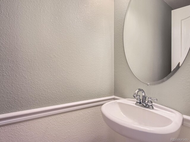 11883 E Fair Ave, Greenwood Village, CO 80111 - bathroom featuring a sink and a textured wall