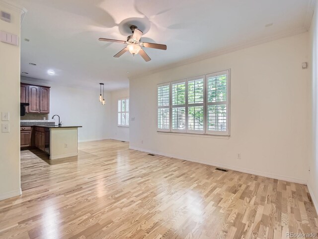 11883 E Fair Ave, Greenwood Village, CO 80111 - unfurnished living room with light wood-type flooring, ceiling fan, ornamental molding, and recessed lighting