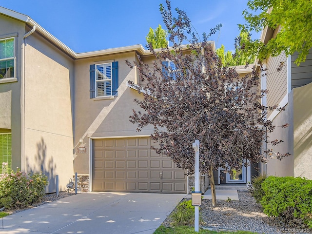 11883 E Fair Ave, Greenwood Village, CO 80111 - view of front of home featuring driveway and stucco siding