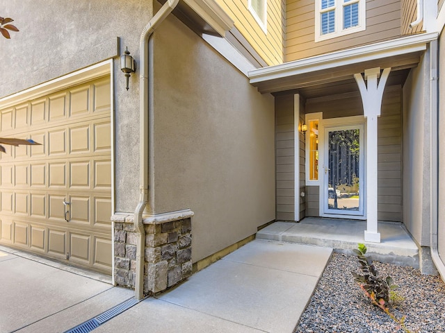 11883 E Fair Ave, Greenwood Village, CO 80111 - property entrance featuring a garage and stucco siding