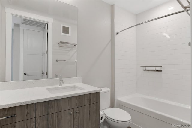 full bathroom with vanity, toilet, and tiled shower / bath