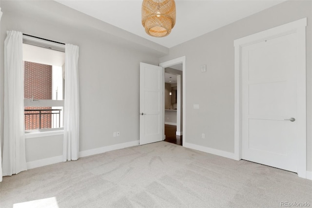 unfurnished bedroom featuring light colored carpet