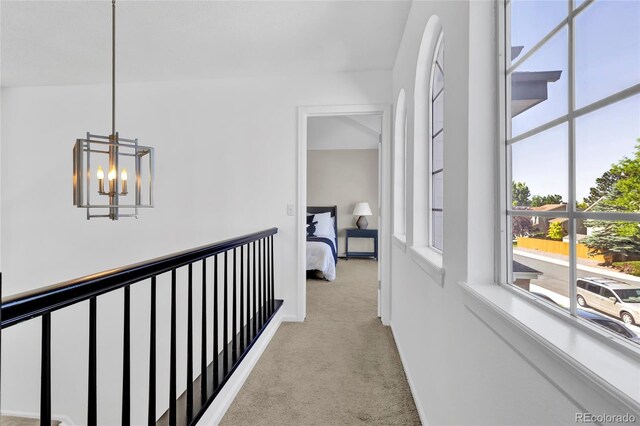 275 S Pembrook St, Castle Rock, CO 80104 - hallway featuring light colored carpet, a chandelier, and baseboards