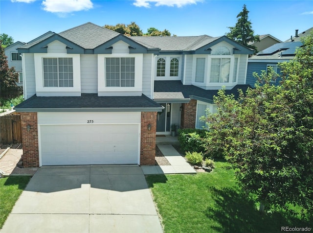 275 S Pembrook St, Castle Rock, CO 80104 - view of front of house with brick siding, an attached garage, driveway, and a shingled roof