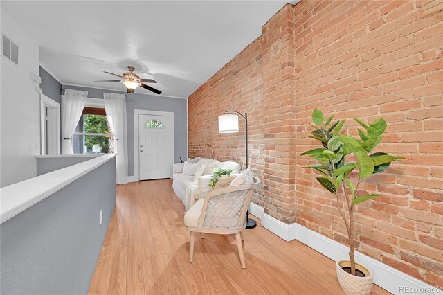 1005 S Pennsylvania St, Denver, CO 80209 - sitting room featuring brick wall, light wood finished floors, and a ceiling fan