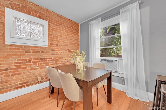 1005 S Pennsylvania St, Denver, CO 80209 - dining room with brick wall, light wood-style floors, and cooling unit