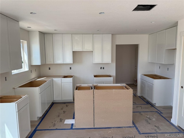 701 Little Bear, Colorado Springs, CO 80907 - kitchen with a center island and white cabinets
