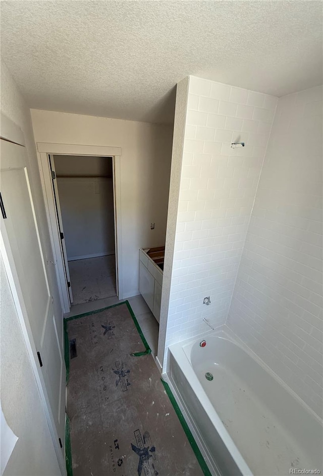 701 Little Bear, Colorado Springs, CO 80907 - full bathroom featuring a textured ceiling and bathing tub / shower combination
