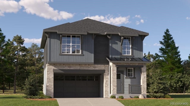 view of front of home with a front yard and a garage