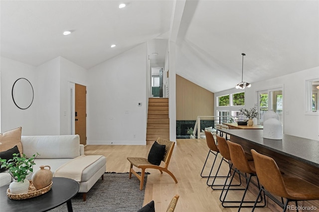 4269 Carter Trl, Boulder, CO 80301 - living room featuring light wood-type flooring, vaulted ceiling, and stairs