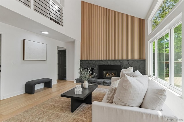 4269 Carter Trl, Boulder, CO 80301 - living room with a high ceiling, plenty of natural light, wood finished floors, a fireplace, and baseboards