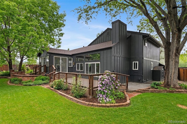 4269 Carter Trl, Boulder, CO 80301 - rear view of house with board and batten siding, a deck, and roof with shingles