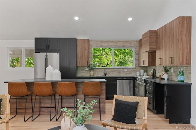 4269 Carter Trl, Boulder, CO 80301 - kitchen with appliances with stainless steel finishes, dark countertops, a sink, tasteful backsplash, and recessed lighting