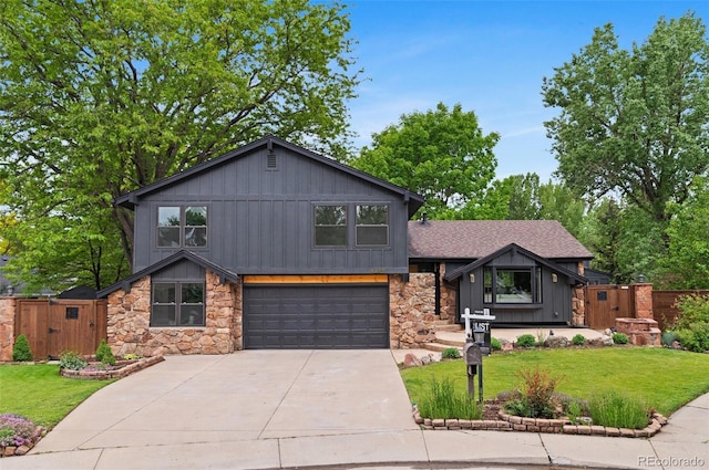 4269 Carter Trl, Boulder, CO 80301 - tri-level home featuring stone siding, a gate, a garage, and concrete driveway