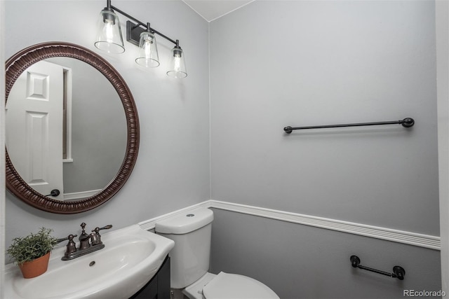 half bathroom with toilet and vanity