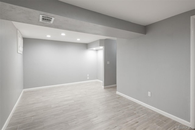 finished basement with recessed lighting, visible vents, baseboards, and light wood-style flooring