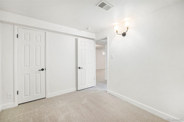 unfurnished bedroom featuring light colored carpet