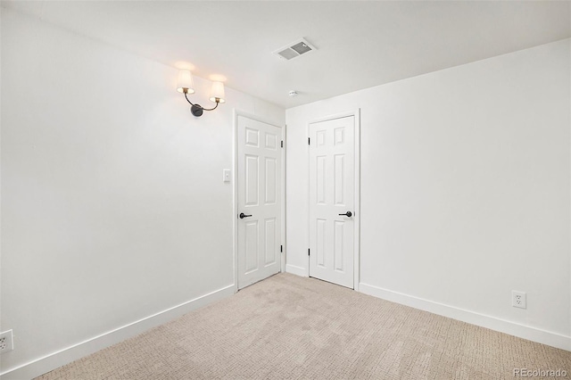 unfurnished room with light carpet