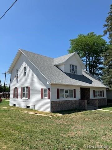 440 Colorado Ave, Stratton, CO 80836 - view of side of home featuring a yard, stone siding, and roof with shingles