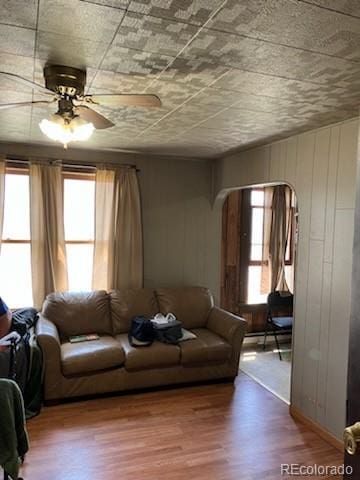 440 Colorado Ave, Stratton, CO 80836 - living room with arched walkways, wood finished floors, and ceiling fan