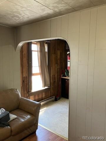 440 Colorado Ave, Stratton, CO 80836 - living area with arched walkways, a decorative wall, and wood finished floors