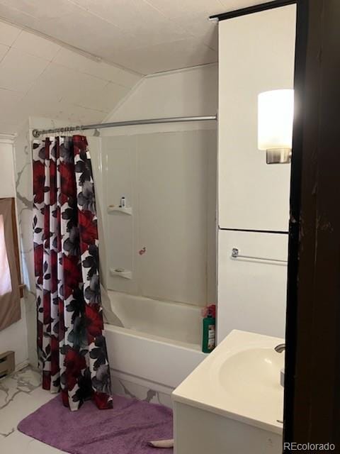 440 Colorado Ave, Stratton, CO 80836 - full bathroom with shower / bath combo with shower curtain, marble finish flooring, vanity, and lofted ceiling