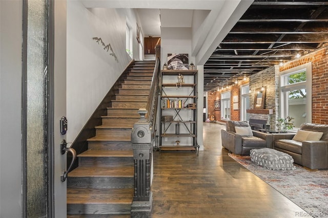 3410 Pecos St, Denver, CO 80211 - staircase with brick wall, wood finished floors, and a large fireplace
