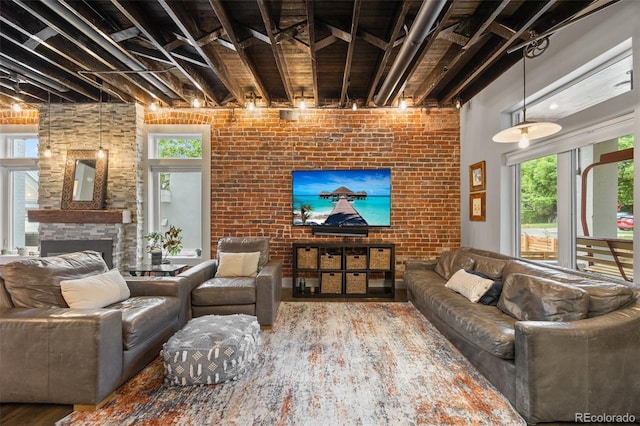 3410 Pecos St, Denver, CO 80211 - living room with a fireplace, wood finished floors, healthy amount of natural light, and brick wall