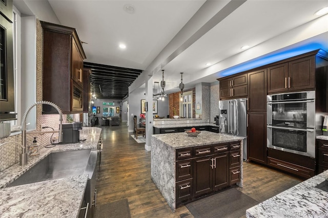3410 Pecos St, Denver, CO 80211 - kitchen featuring stainless steel appliances, dark wood-type flooring, dark brown cabinets, light stone counters, and recessed lighting
