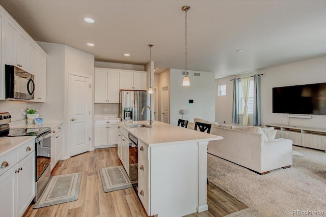 4505 Cholla Trl, Castle Rock, CO 80104 - kitchen featuring black appliances, open floor plan, light wood-type flooring, light countertops, and white cabinets