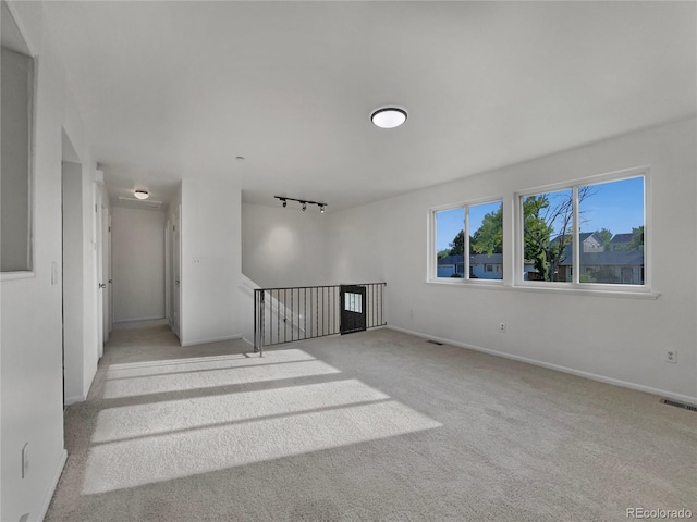 12238 Monroe Dr, Thornton, CO 80241 - carpeted empty room featuring rail lighting and baseboards