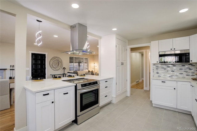 kitchen with tasteful backsplash, appliances with stainless steel finishes, white cabinets, island range hood, and light stone countertops