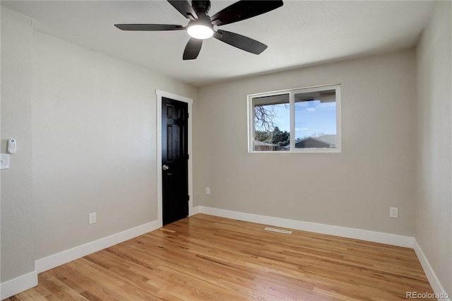 unfurnished room with light wood-style floors, baseboards, and ceiling fan