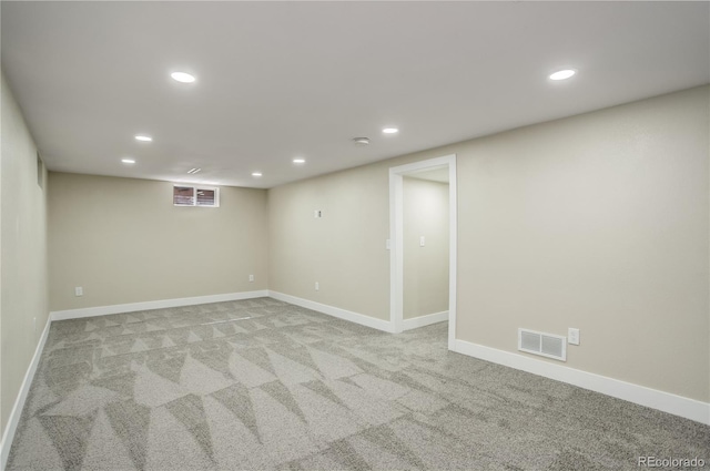 finished below grade area featuring recessed lighting, visible vents, and baseboards